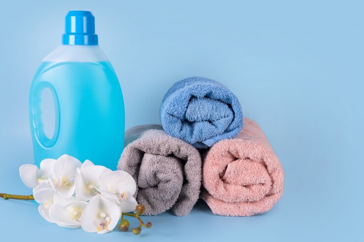 bottle detergent with clean towels flowers blue background 99272 3300 1