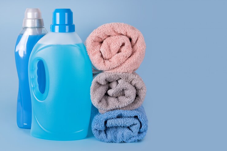bottles detergent fabric softener with clean towels blue background 99272 3314