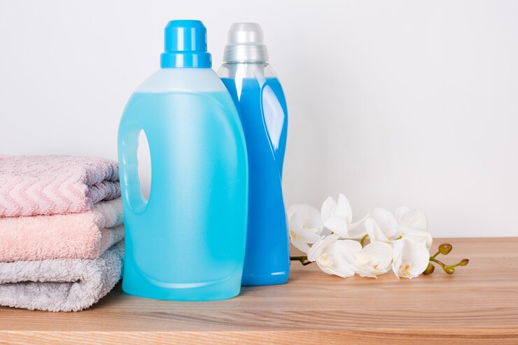 bottles detergent fabric softener with clean towels orchid flowers wooden table 99272 3296