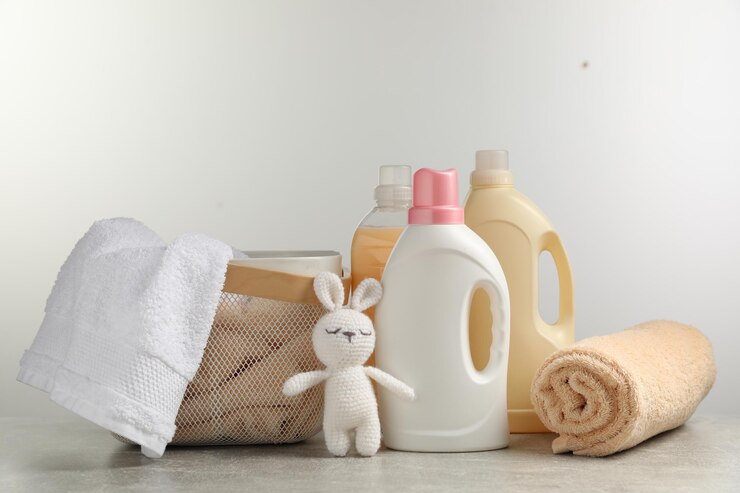 bottles laundry detergents fresh towels knitted rabbit toy grey table against white background 495423 47411