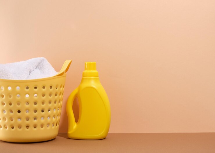 bright-yellow-laundry-basket-with-dirty-towel-laundry-detergent-beige-background-copy-space-text_594847-2909