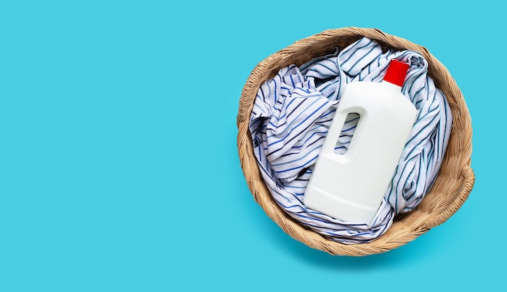 clothes with plastic bottle detergent laundry basket blue background copy space 51524 7858 1