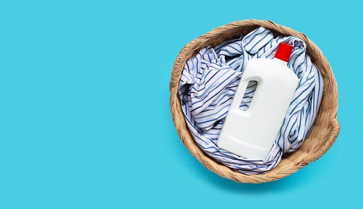 clothes-with-plastic-bottle-detergent-laundry-basket-blue-background-copy-space_51524-7858