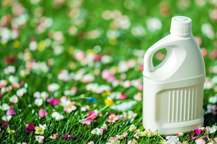 detergent bottle grass with background scattered flower petals 762026 134072 1
