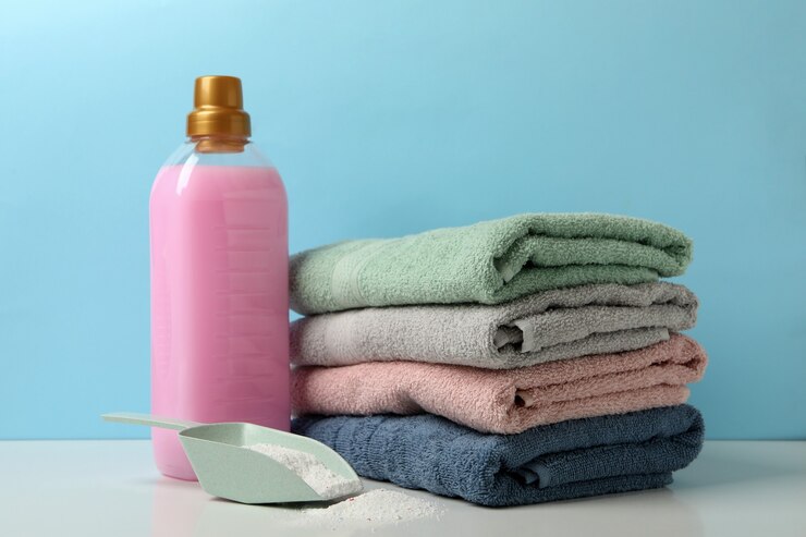 detergent scoop with powder towels white table against blue background 185193 27659