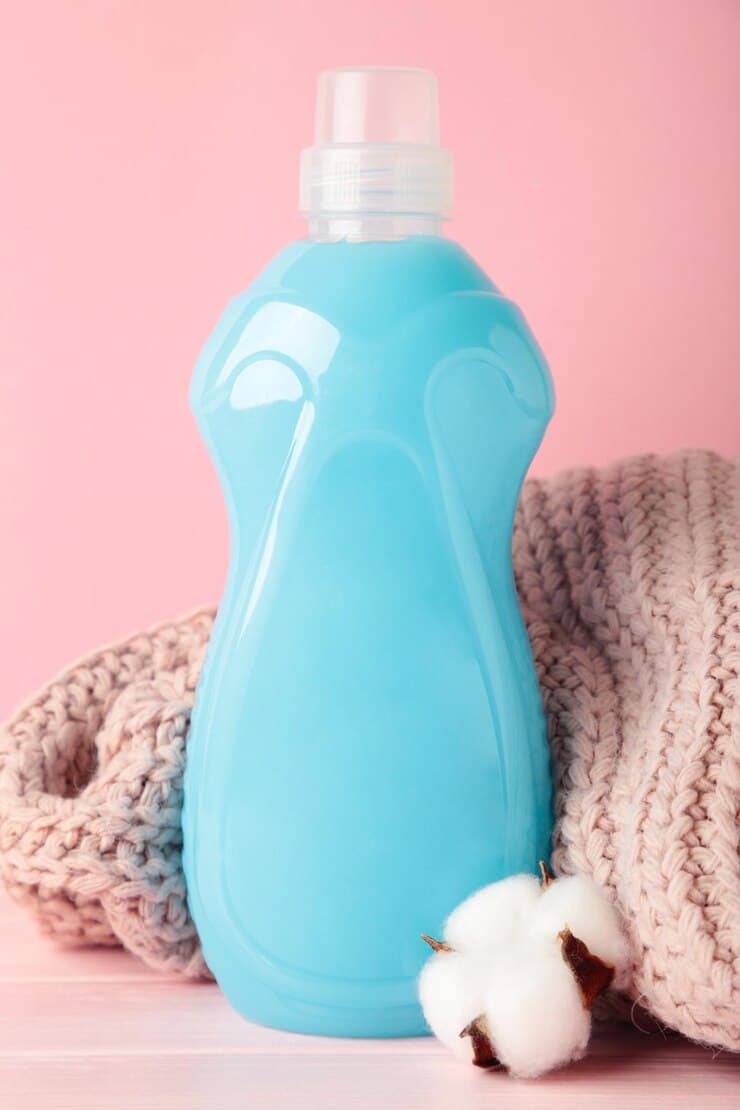 eco washing concept laundry detergent cotton flowers pink sweater pink background copy space vertical photo 106006 9470 1