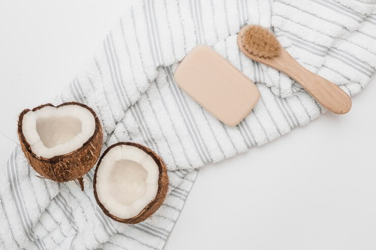 elevated view halved coconut towel soap brush white backdrop 23 2147927164 1