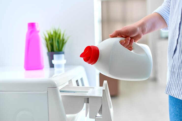 female housewife pouring fabric softener gel into modern washing laundry machine 122732 3962