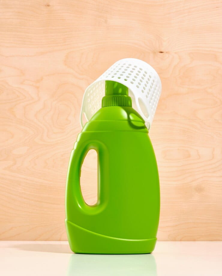 green large bottle liquid laundry detergent white laundry basket wooden background 594847 9867 1