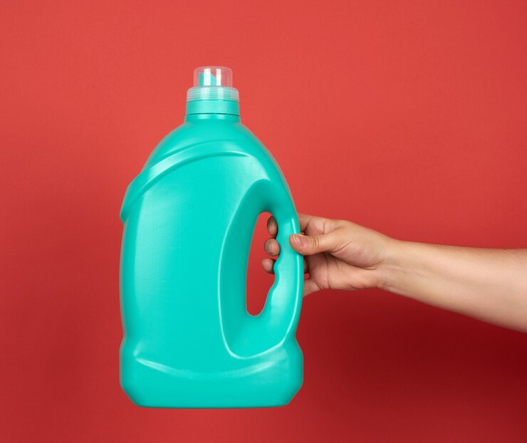 hand holds green big bottle with liquid detergent washing clothes 116441 12062