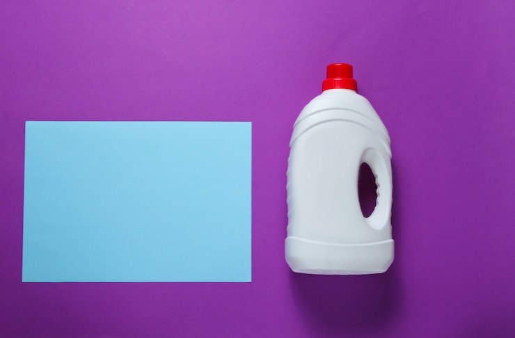 minimalistic-concept-washing-blue-paper-sheet-copy-space-bottle-washing-gel-purple-table-top-view_175682-4764