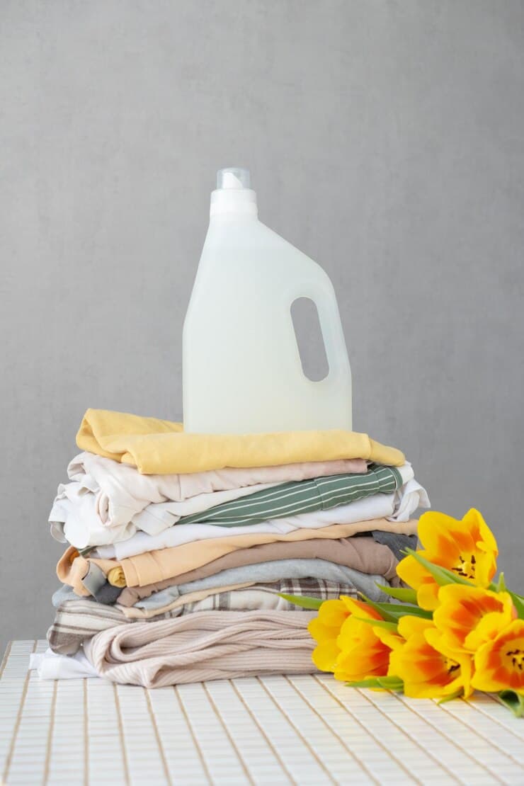 mock up conditioner laundry gel against stack clean clothes table with tulip flowers 423170 4644 1