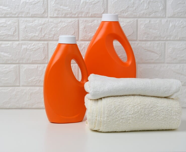 orange plastic bottle liquid washing powder folded towels white shelf 116441 18890 1