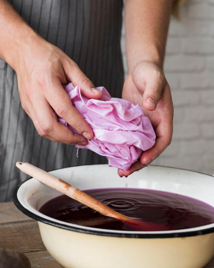 person squeezing cloth from natural dye close up 23 2148734392 1