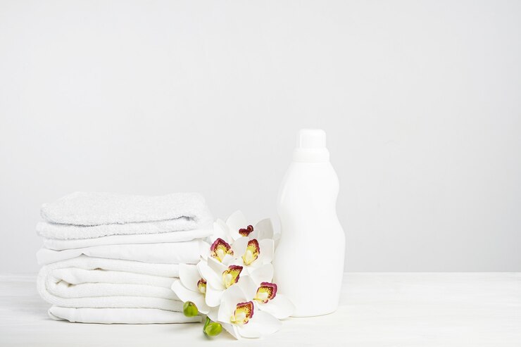 stack white linen washing gel fabric softener white table with orchid flowers mockup laundry day tropical hotel with copy space 226439 242